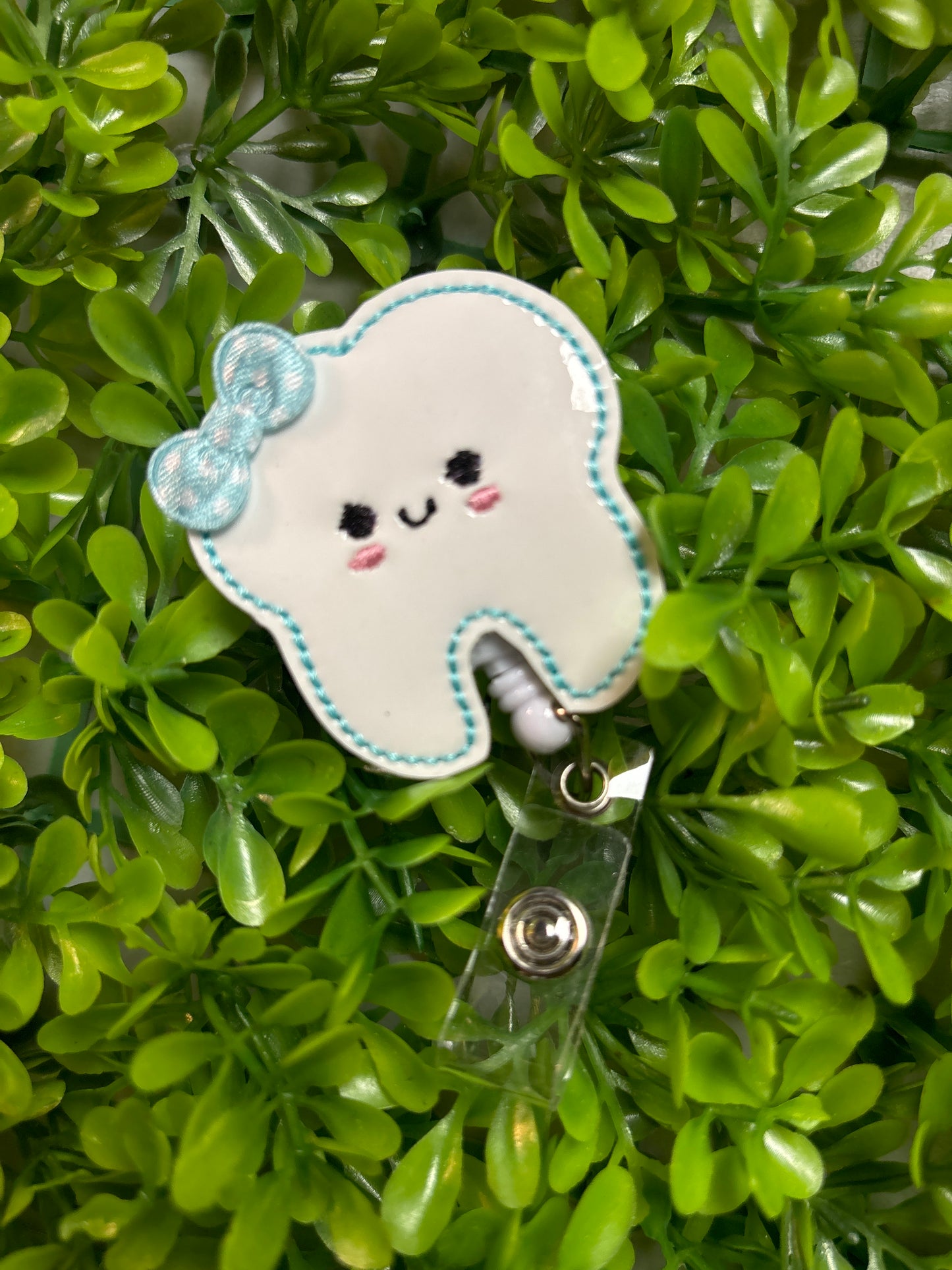 Tooth with Blue Bow Badge Reel